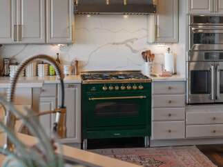 Experience culinary excellence in this stunning kitchen, featuring a professional-grade emerald green range with brass accents.