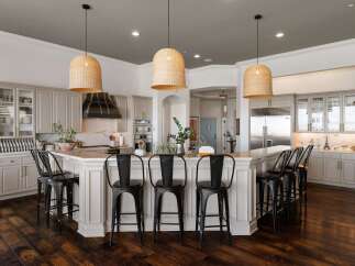 Experience luxury in this stunning kitchen featuring a large island with bar seating, perfect for entertaining.