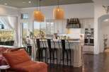 Experience luxury living in this stunning kitchen featuring a large island with bar seating, perfect for entertaining.