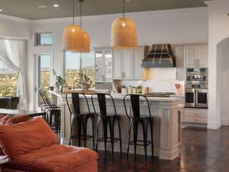 Experience luxury living in this stunning kitchen featuring a large island with bar seating, perfect for entertaining.