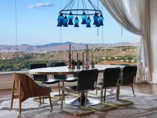 Experience breathtaking panoramic views from this elegant dining room, featuring a large oval table and stylish chairs perfect for entertaining.