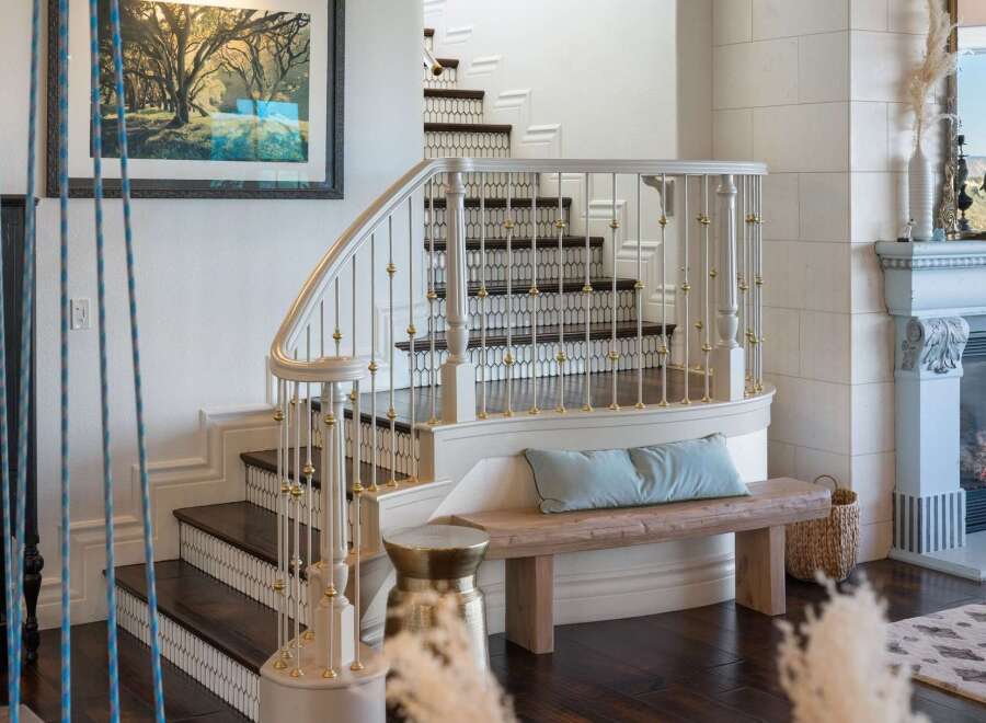 This elegant home features a grand staircase with a curved banister and ornate railings, perfect for making a statement.