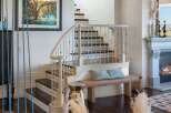 This elegant home features a grand staircase with a curved banister and ornate railings, perfect for making a statement.