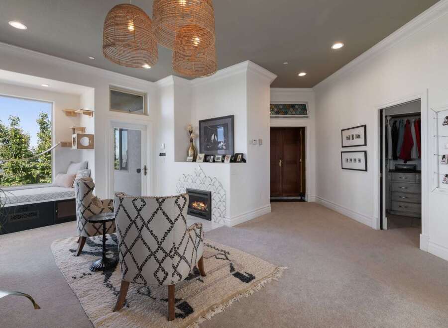This inviting living space features a cozy fireplace with decorative tile surround, perfect for gathering.
