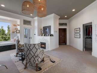 This inviting living space features a cozy fireplace with decorative tile surround, perfect for gathering.
