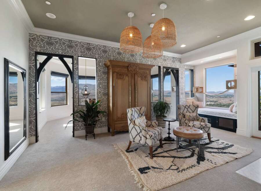 Experience breathtaking panoramic views from this stunning bedroom, featuring a cozy window seat perfect for enjoying the scenery.