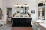 Experience luxury in this stunning bathroom featuring a double vanity with marble countertops and ornate mirrors.