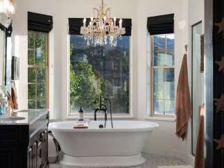 Indulge in luxury in this stunning bathroom featuring a freestanding soaking tub with a breathtaking mountain view.