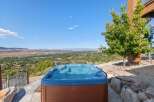 Experience ultimate relaxation with this stunning hot tub, offering breathtaking panoramic views of the valley below.