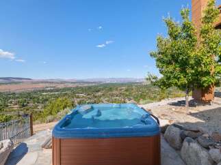 Experience ultimate relaxation with this stunning hot tub, offering breathtaking panoramic views of the valley below.