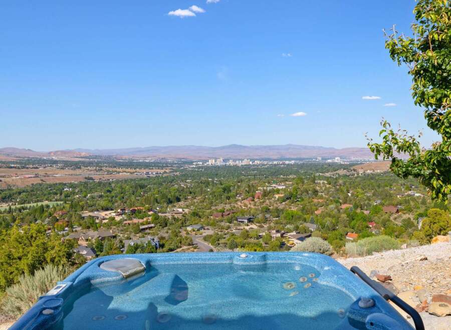 Experience breathtaking panoramic views from this stunning property, featuring a luxurious hot tub perfect for relaxation.