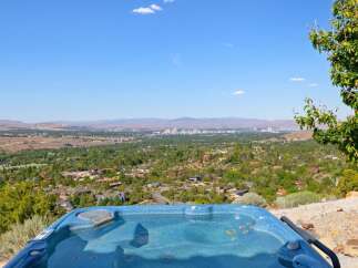 Experience breathtaking panoramic views from this stunning property, featuring a luxurious hot tub perfect for relaxation.