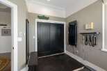This home gym features a black double door leading to a workout space with a dark floor.