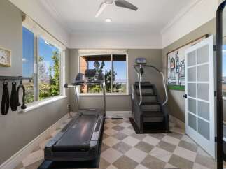 Elevate your fitness routine in this dedicated home gym, featuring a treadmill and stair climber for a comprehensive workout.