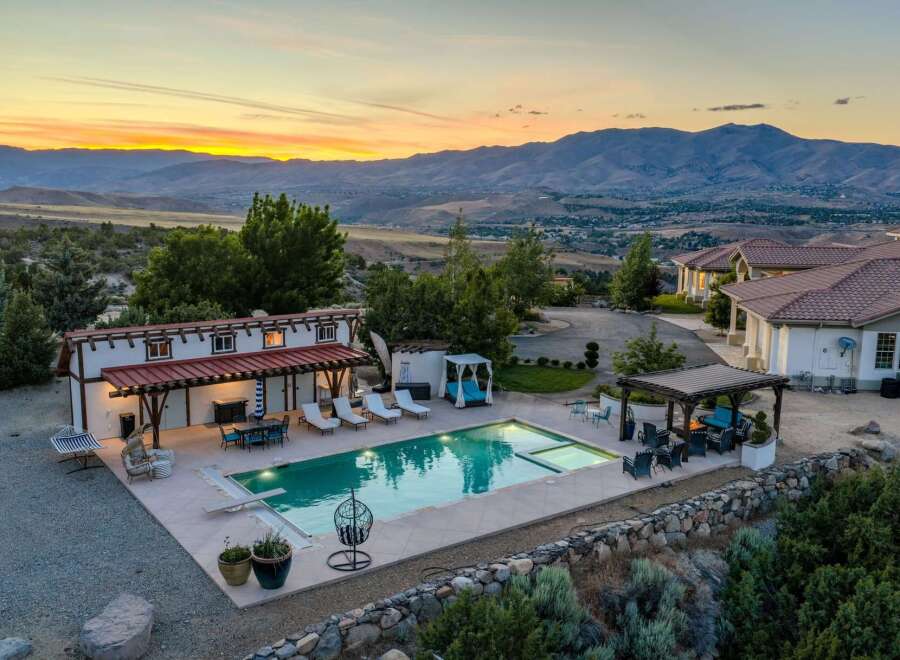 Experience luxury living with this stunning estate featuring a sparkling swimming pool and expansive outdoor entertaining areas.
