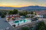 Experience luxury living with this stunning estate featuring a sparkling swimming pool and expansive outdoor entertaining areas.