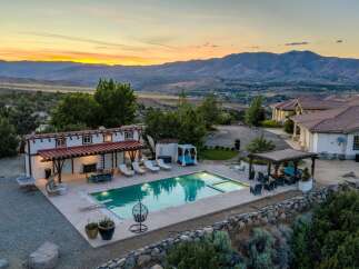 Experience luxury living with this stunning estate featuring a sparkling swimming pool and expansive outdoor entertaining areas.