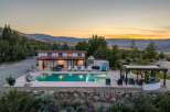 Experience luxurious outdoor living with this stunning property featuring a sparkling swimming pool and an inviting hot tub, perfect for relaxation.