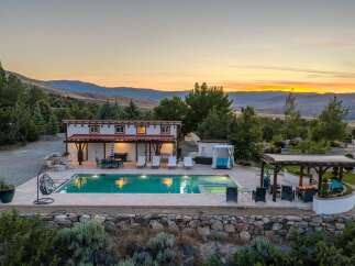 Experience luxurious outdoor living with this stunning property featuring a sparkling swimming pool and an inviting hot tub, perfect for relaxation.