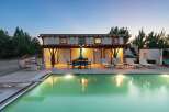 Experience luxury outdoor living with this stunning property featuring a sparkling swimming pool and a covered patio perfect for al fresco dining.