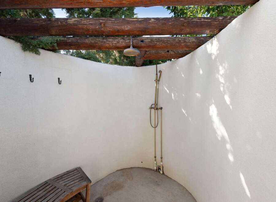 Experience ultimate relaxation with this charming outdoor shower, perfect for rinsing off after a swim or enjoying a refreshing moment in nature.