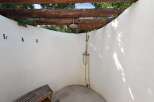 Experience ultimate relaxation with this charming outdoor shower, perfect for rinsing off after a swim or enjoying a refreshing moment in nature.