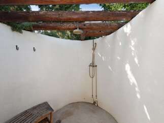 Experience ultimate relaxation with this charming outdoor shower, perfect for rinsing off after a swim or enjoying a refreshing moment in nature.
