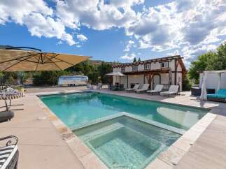 Escape to this stunning desert oasis featuring a sparkling swimming pool and integrated hot tub, perfect for relaxation and entertainment.