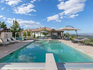 Experience luxury outdoor living with this stunning backyard oasis, featuring a sparkling swimming pool and relaxing hot tub.