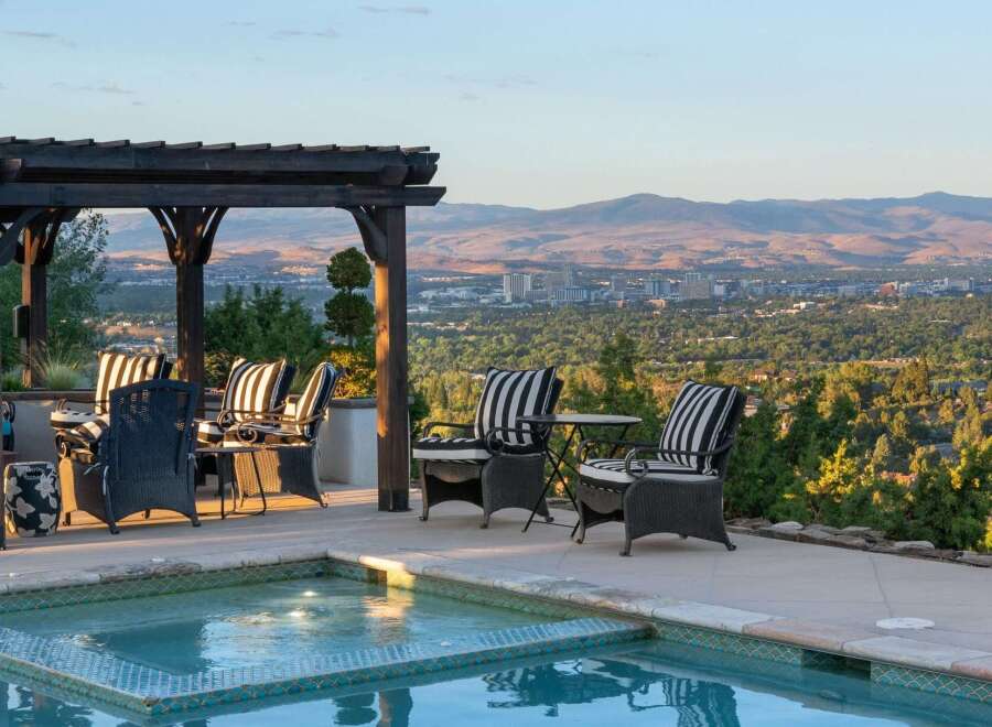 Enjoy breathtaking panoramic views of the city and mountains from this stunning outdoor living space.