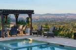 Enjoy breathtaking panoramic views of the city and mountains from this stunning outdoor living space.
