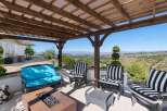 Enjoy breathtaking panoramic views from this stunning covered patio, perfect for outdoor entertaining.