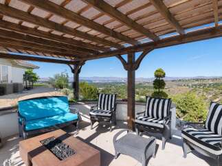Enjoy breathtaking panoramic views from this stunning covered patio, perfect for outdoor entertaining.