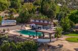 Experience luxury outdoor living with this stunning property featuring a sparkling swimming pool and a covered patio perfect for entertaining.