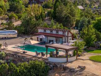 Experience luxury outdoor living with this stunning property featuring a sparkling swimming pool and a covered patio perfect for entertaining.