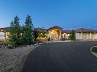 Discover this stunning Mediterranean-style estate, featuring a grand arched entryway with elegant columns and a welcoming ambiance.