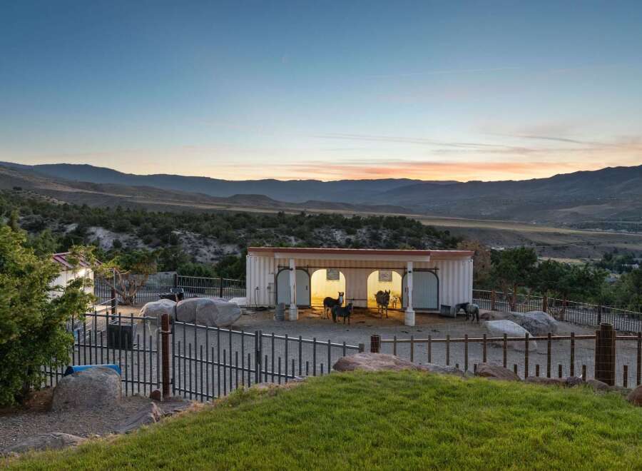 Experience the tranquility of this unique property featuring a modern barn structure with ample space for animals, set against a breathtaking mountain vista.