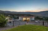 Experience the tranquility of this unique property featuring a modern barn structure with ample space for animals, set against a breathtaking mountain vista.