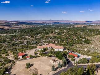 Experience luxury living in this expansive estate, boasting a sprawling main residence with a multi-car garage and a separate guest house.