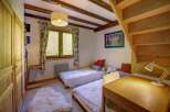Discover this charming bedroom featuring two cozy twin beds, perfect for guests or family.