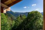 Experience breathtaking mountain views from this charming property, nestled amidst lush greenery.