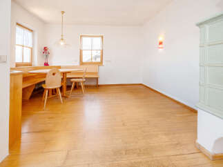 This charming dining area features a cozy built-in wooden bench seating and a round wooden table, perfect for intimate meals.