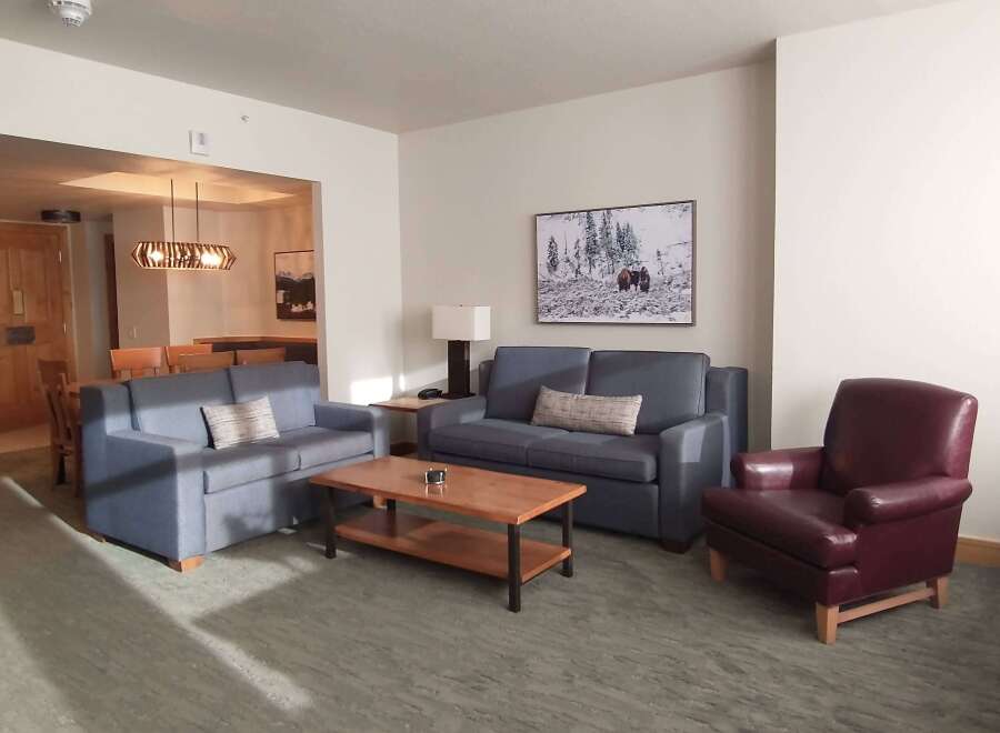 Experience comfort and style in this inviting living space, featuring a plush blue sofa and a matching loveseat perfect for relaxation.
