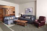 Experience comfort and style in this inviting living space, featuring a plush blue sofa and a matching loveseat perfect for relaxation.