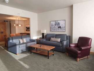 Experience comfort and style in this inviting living space, featuring a plush blue sofa and a matching loveseat perfect for relaxation.