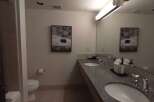 This spacious bathroom features a double vanity with granite countertops and modern fixtures, perfect for busy mornings.