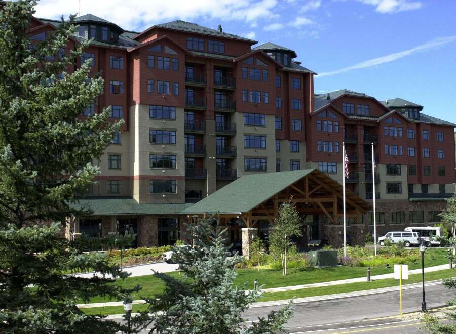 Discover luxury living in this stunning multi-story building, featuring a warm brick exterior and expansive windows.