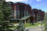 Discover luxury living in this stunning multi-story building, featuring a warm brick exterior and expansive windows.