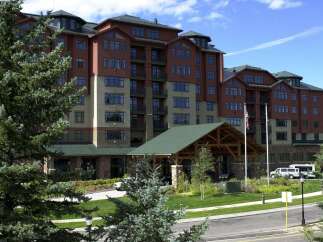 Discover luxury living in this stunning multi-story building, featuring a warm brick exterior and expansive windows.