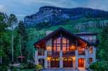 Experience luxury mountain living in this stunning stone and timber home, nestled against a majestic mountain backdrop.